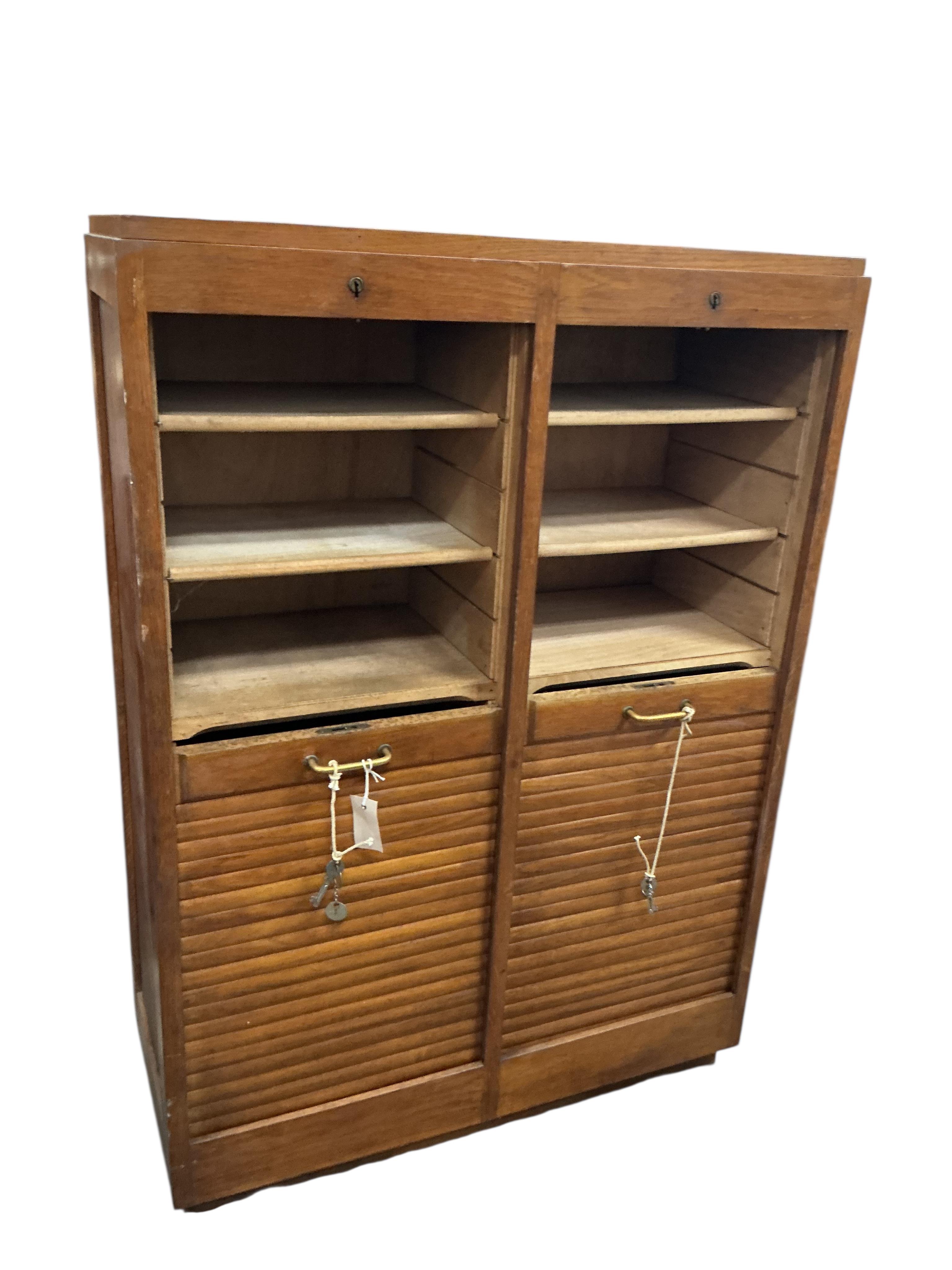 A mid century oak double tambour filing cabinet, width 83cm, depth 36cm, height 118cm